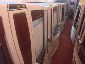a row of white and brown doors on an airplane