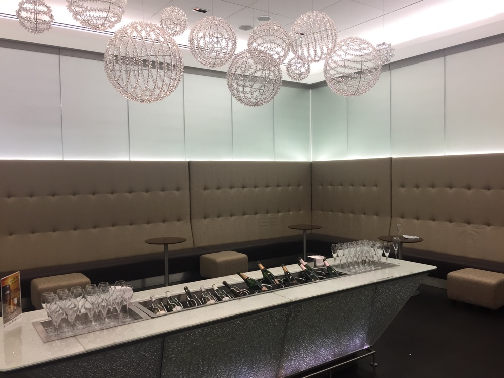 a bar with wine glasses and champagne bottles