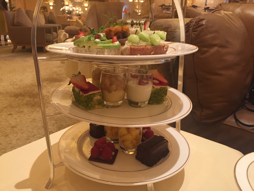 a three tiered tray with desserts on it