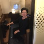 a woman sitting on a seat in a plane