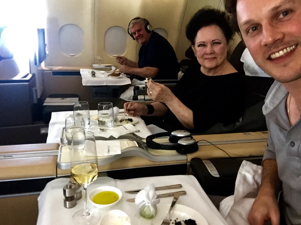 a group of people sitting at a table in an airplane