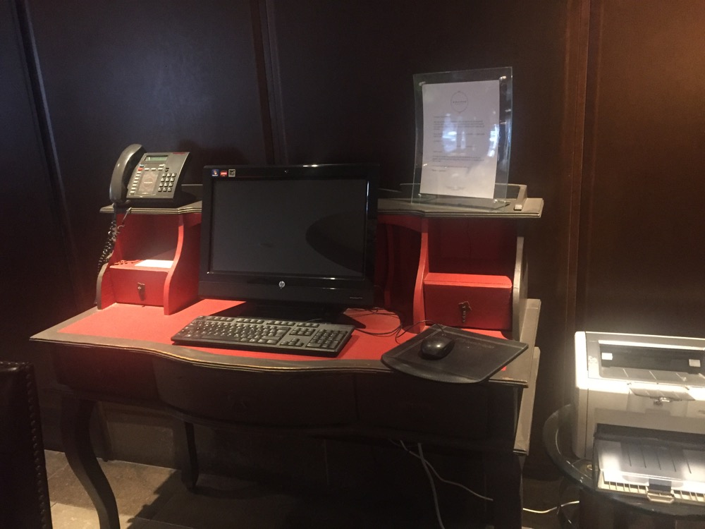 a desk with a computer and a printer
