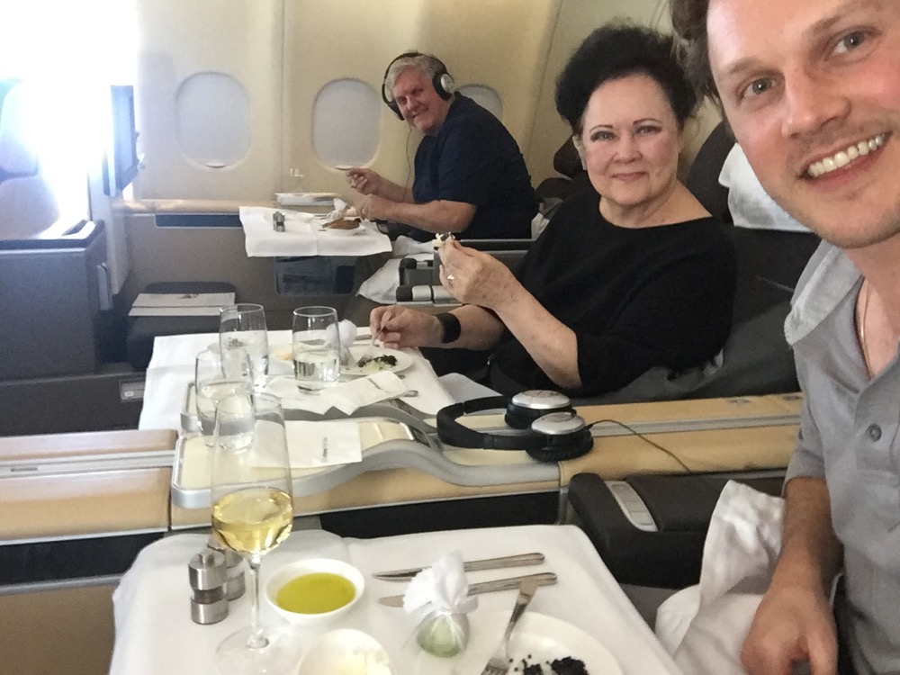 a group of people sitting at a table in an airplane
