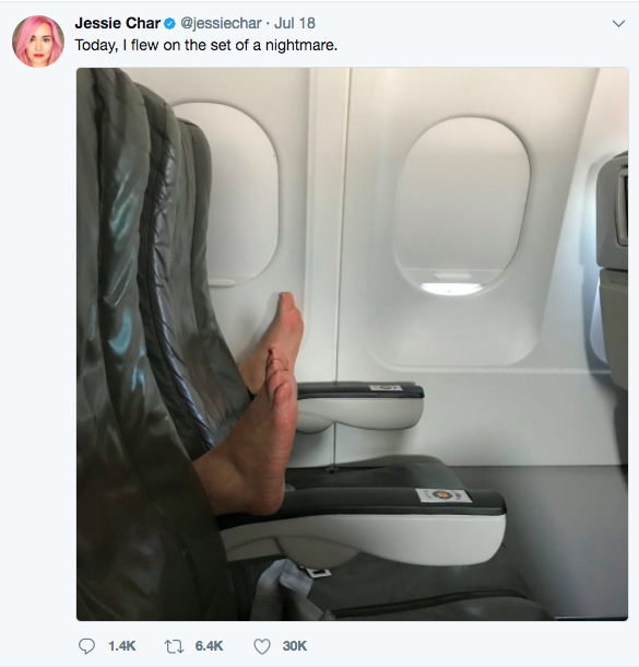 a person's feet in a chair in an airplane