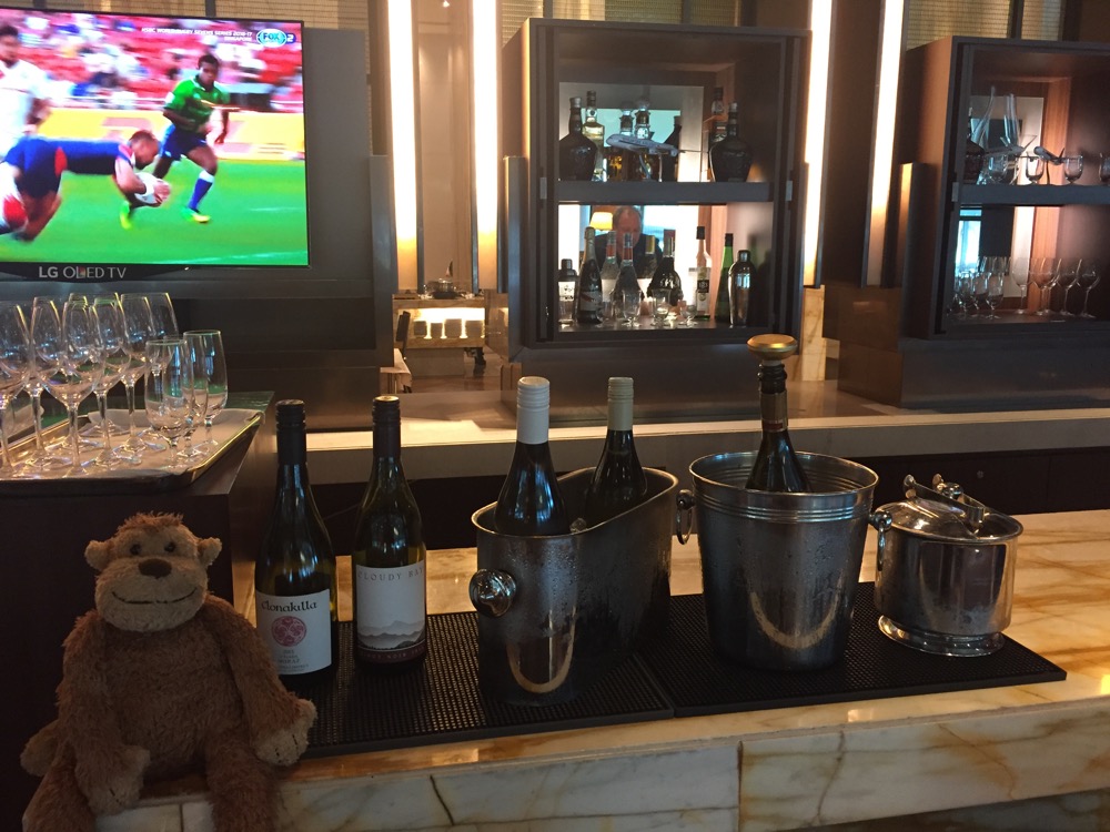 a bar with bottles of wine and a teddy bear
