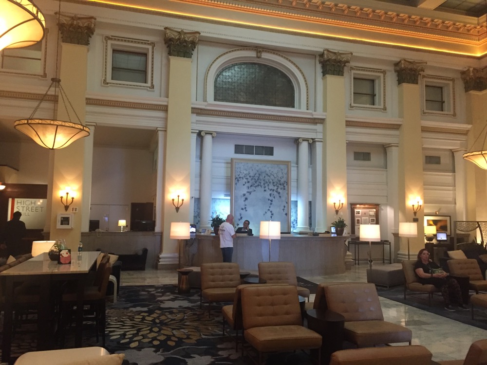 a large lobby with a large white wall and a large white columned ceiling