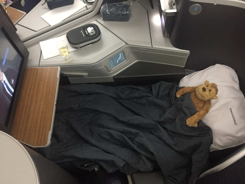 a stuffed bear on a bed