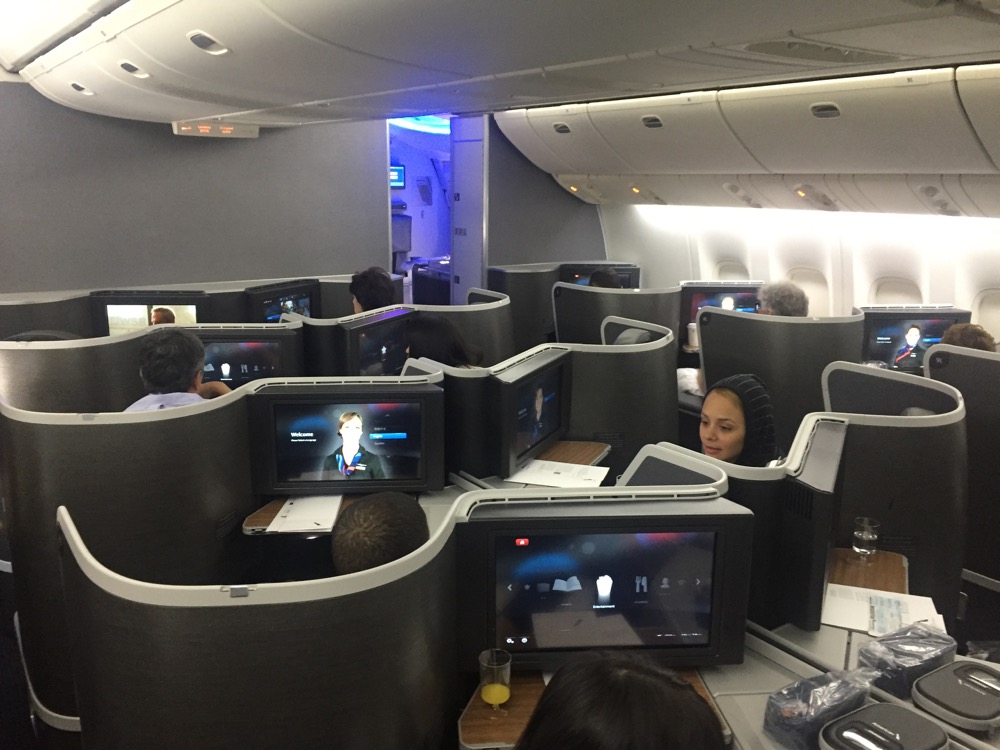 a group of people sitting in a row of monitors