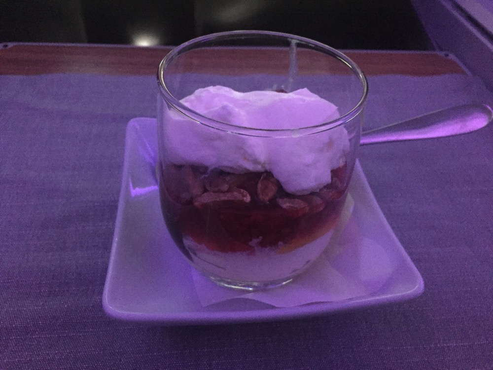 a glass of dessert on a plate