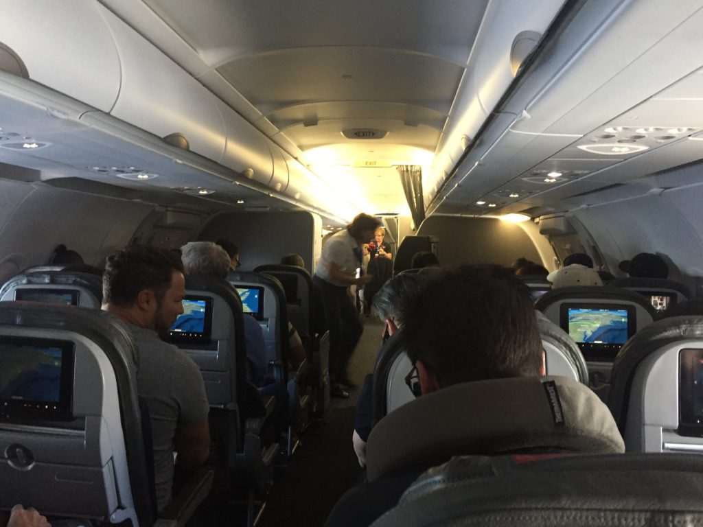 people in an airplane with people sitting in the back