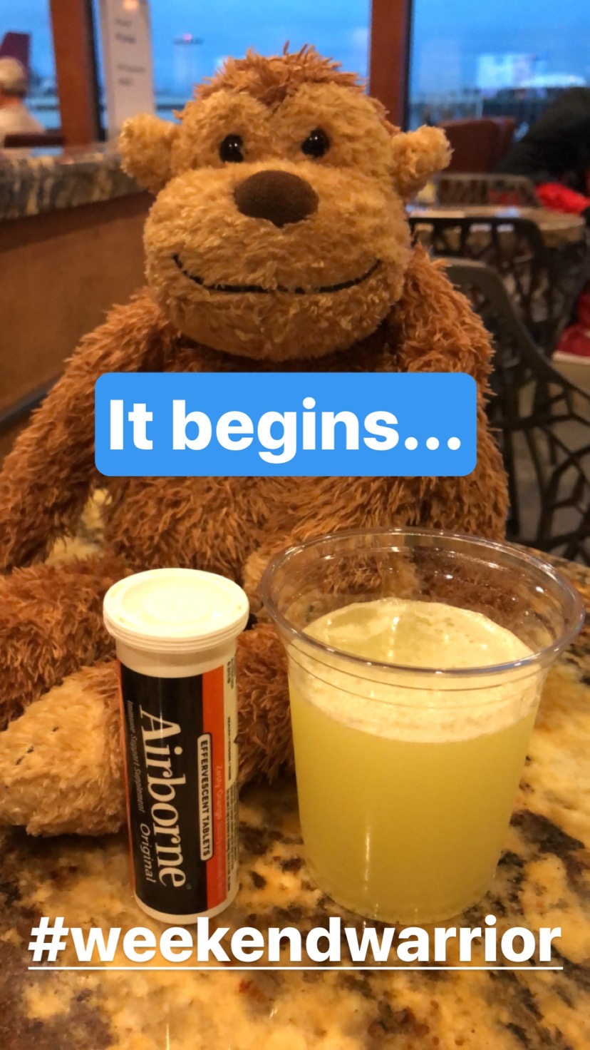 a stuffed animal next to a drink