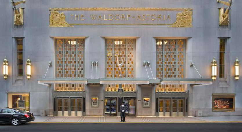 a man standing in front of Waldorf Astoria New York