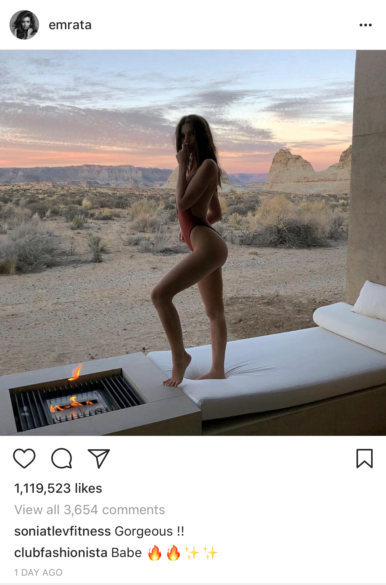a woman in a swimsuit standing on a bed in a desert