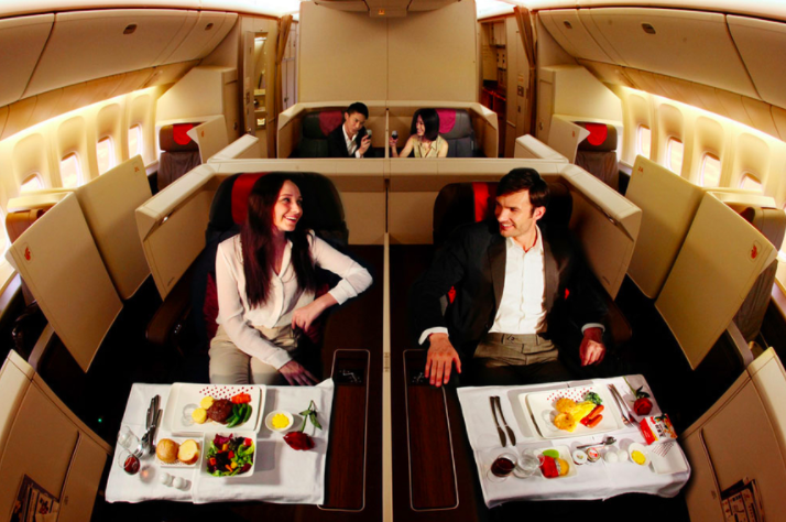 a couple of people sitting at a table in an airplane