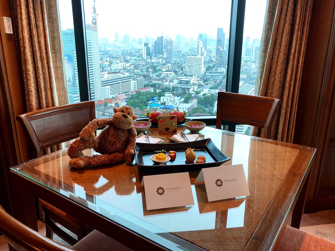 a table with a teddy bear and food on it