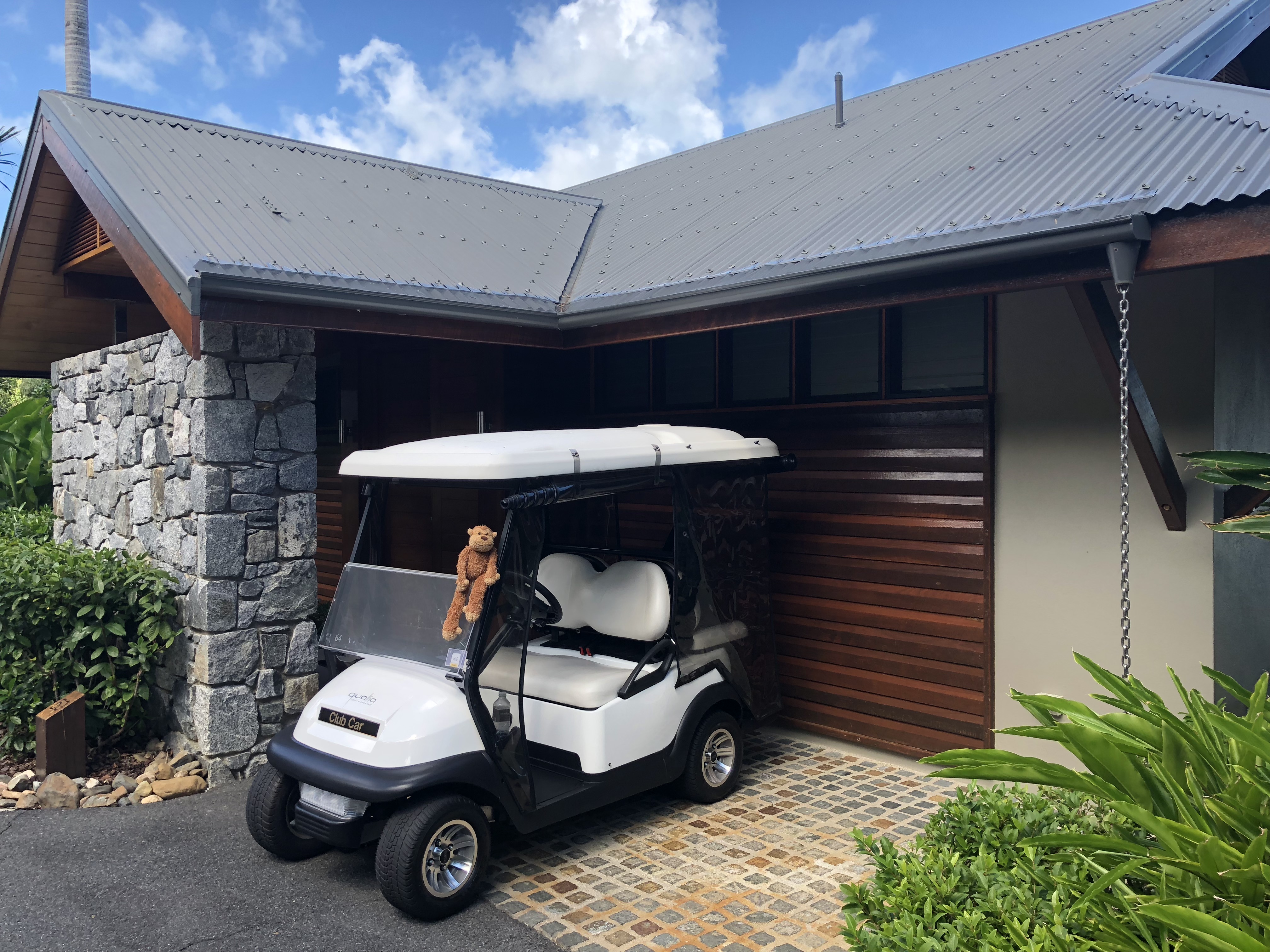 a golf cart parked in front of a garage