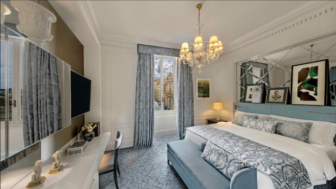 a room with a bed and a chandelier