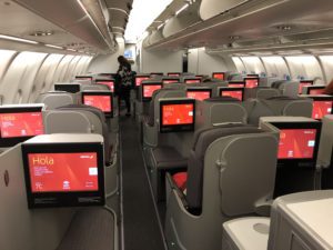 a person standing in an airplane with monitors