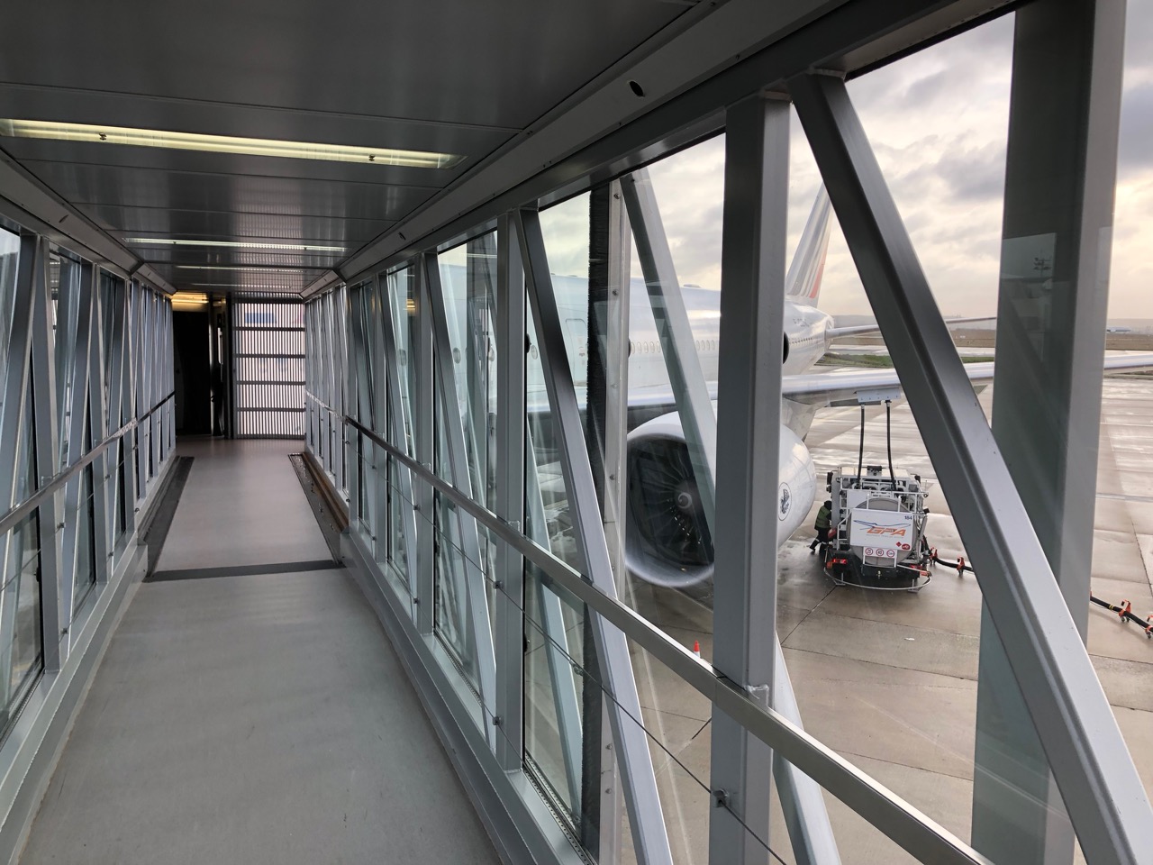 a hallway with a plane on the tarmac