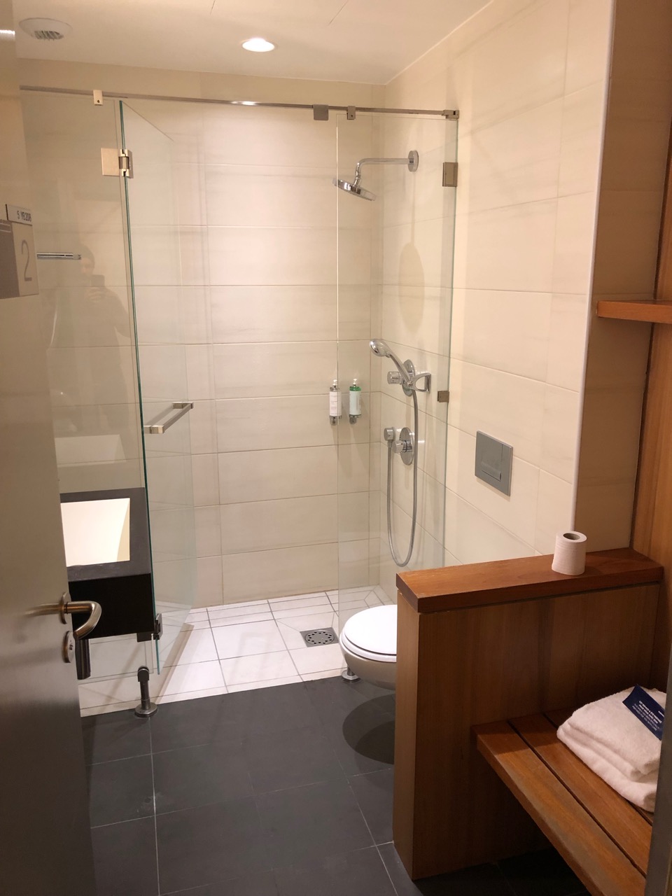 a bathroom with a glass shower door