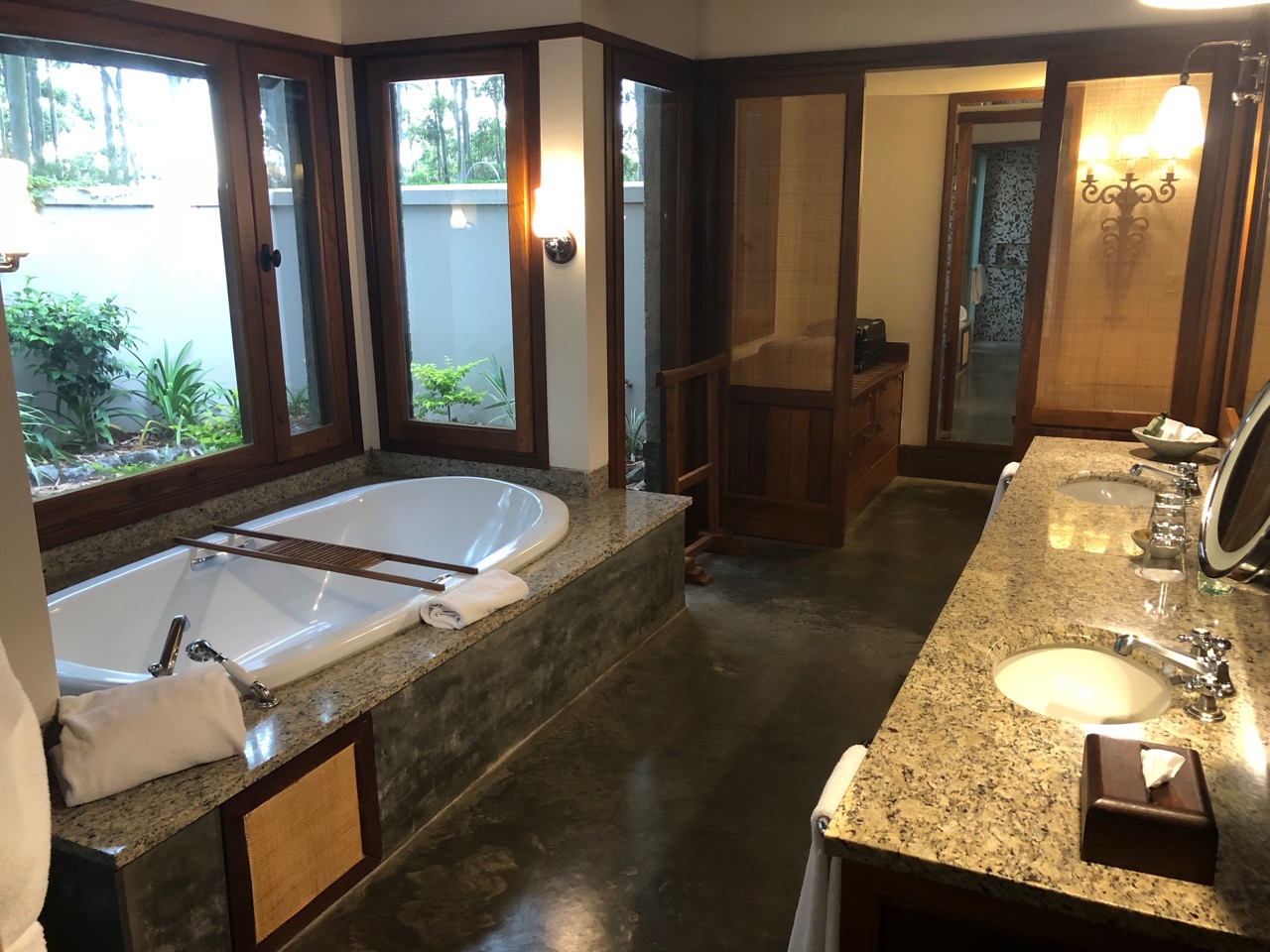 a bathroom with a tub and two sinks