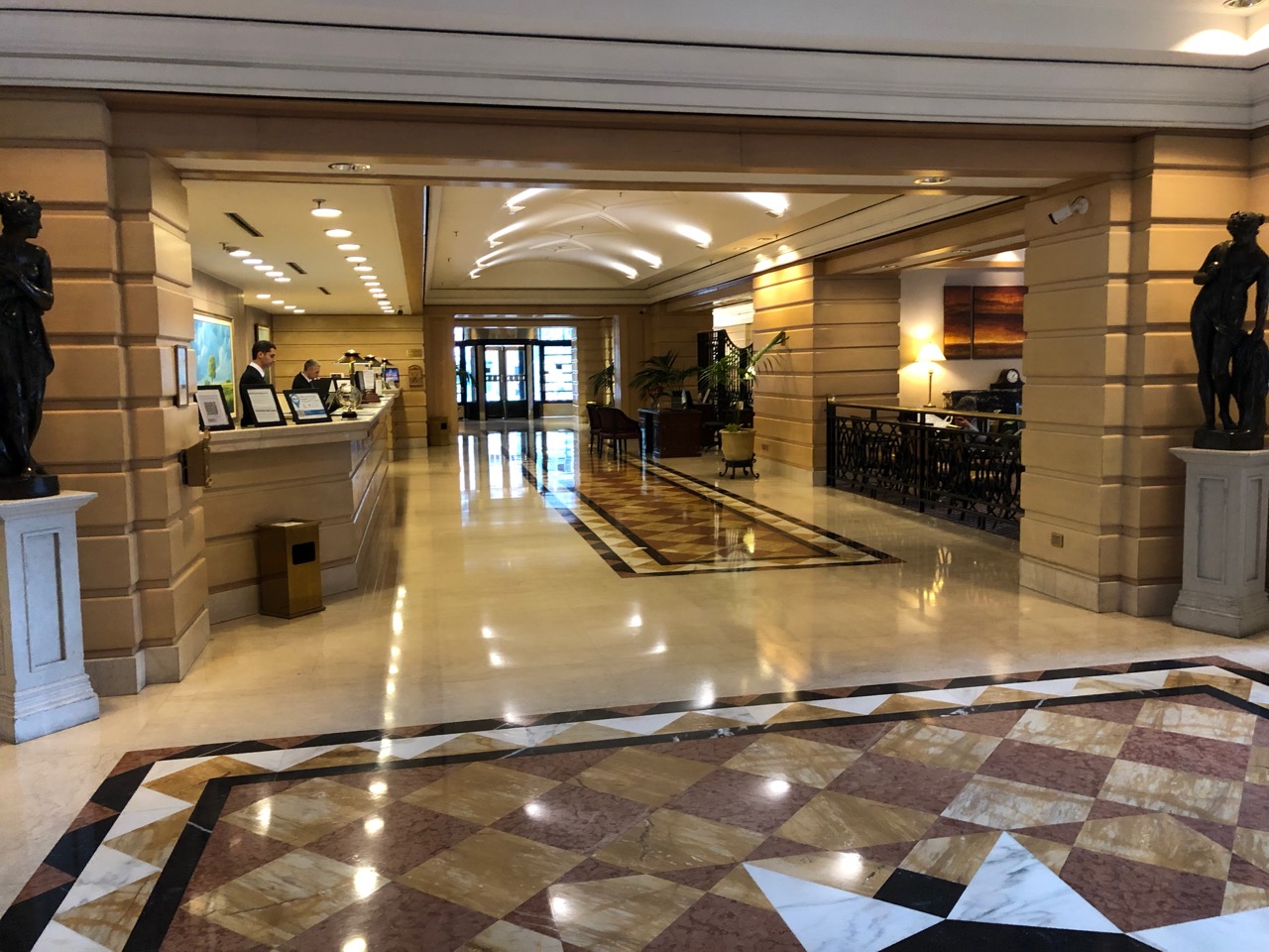 a lobby with a marble floor and a tiled floor