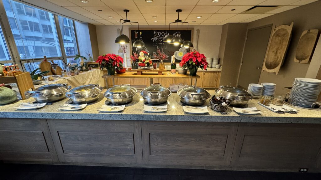 a buffet table with silver bowls on it