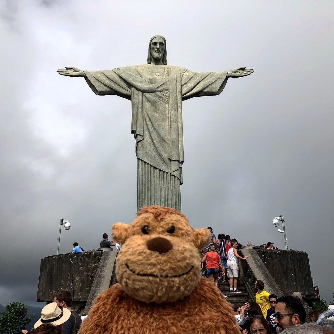 a stuffed animal in front of a statue with Christ the Redeemer in the background