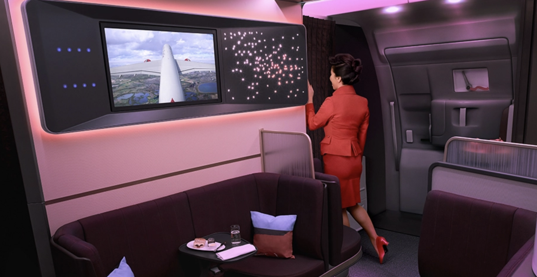 a woman in a red suit walking in a plane