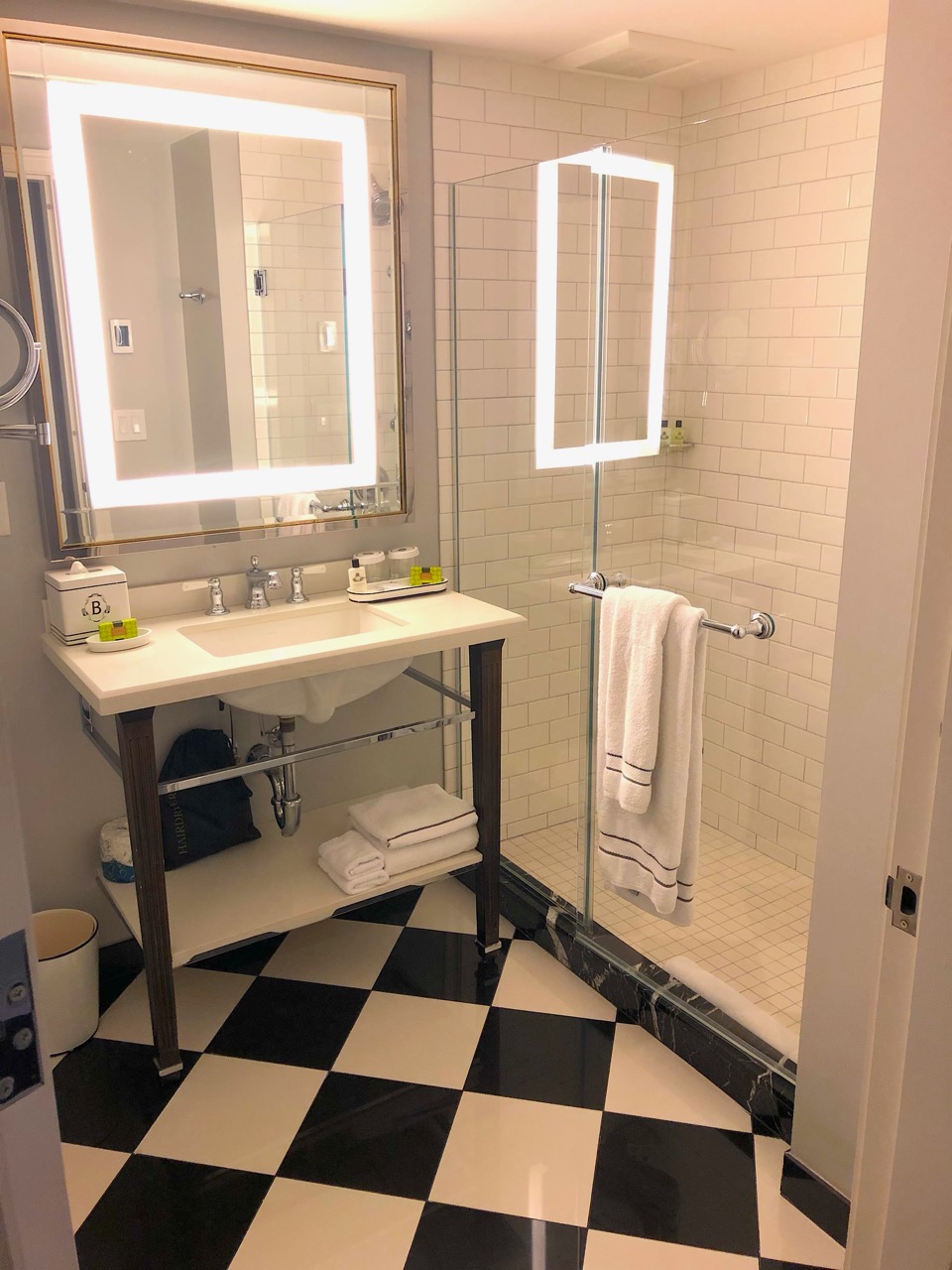 a bathroom with a mirror and a stand up shower