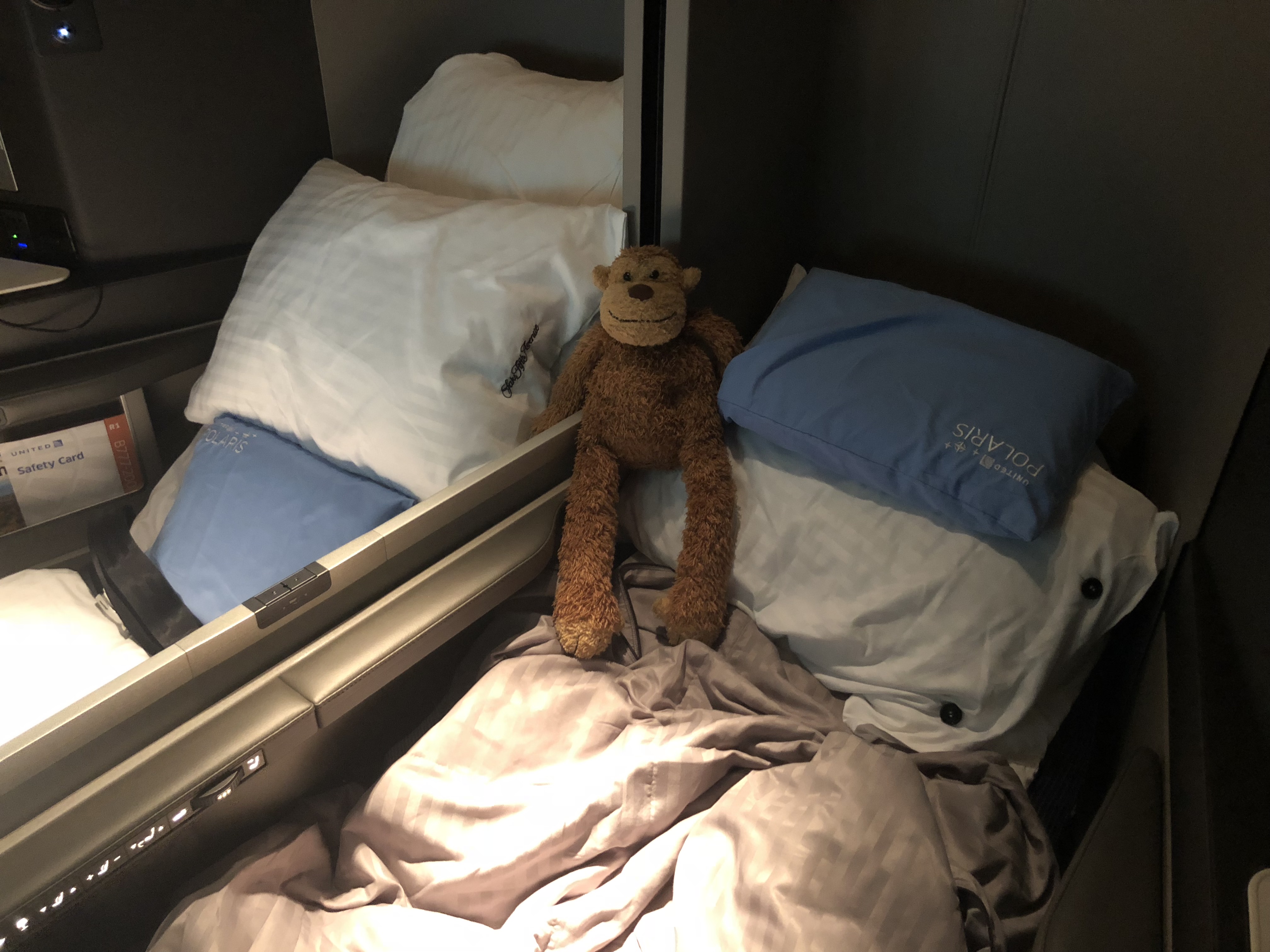 a stuffed monkey on a bed