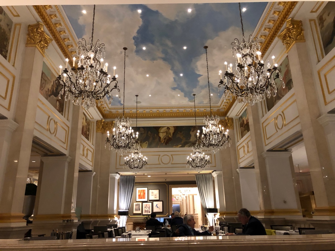 a room with a ceiling and chandeliers