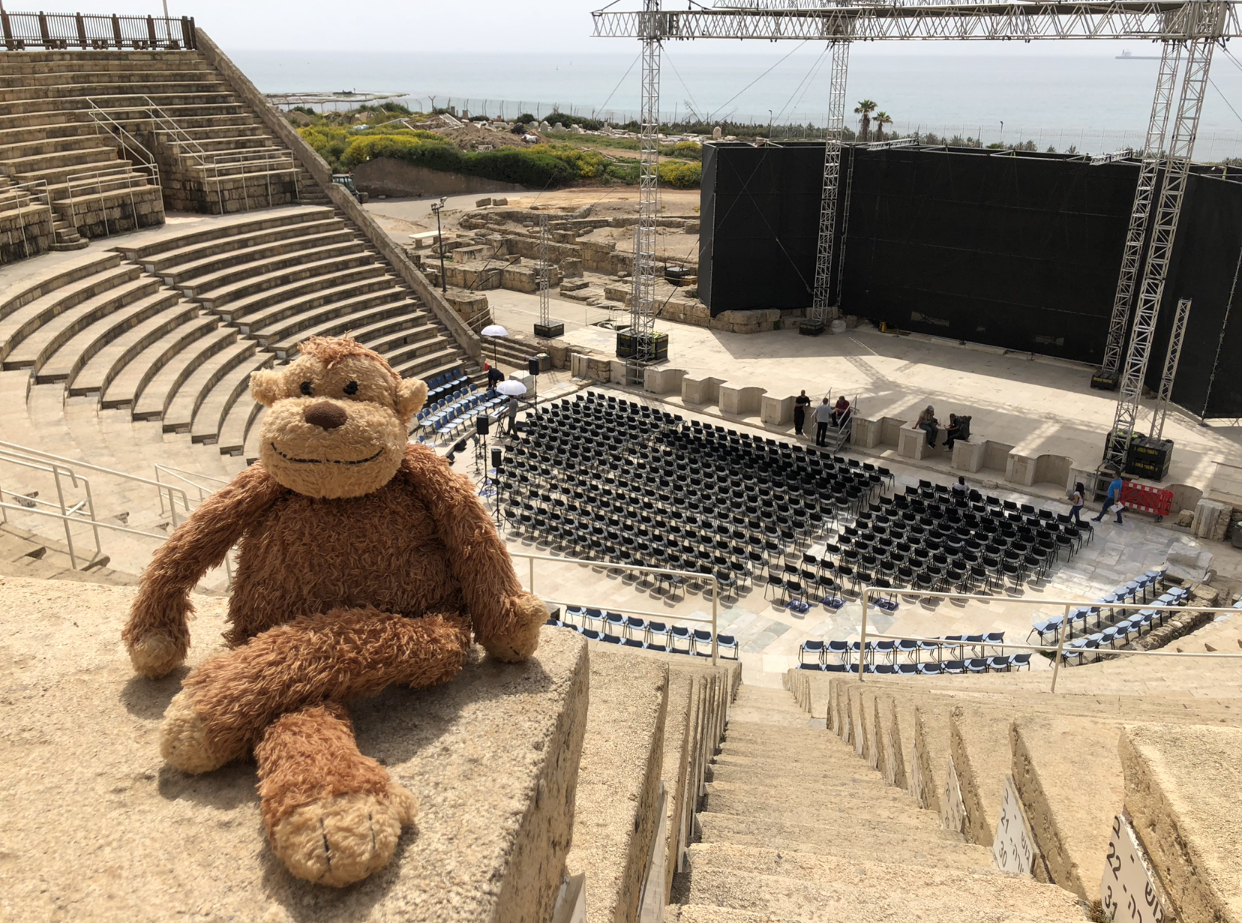 a stuffed animal sitting on a ledge in front of an empty stage