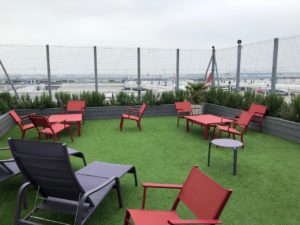 a group of chairs and tables on a green lawn