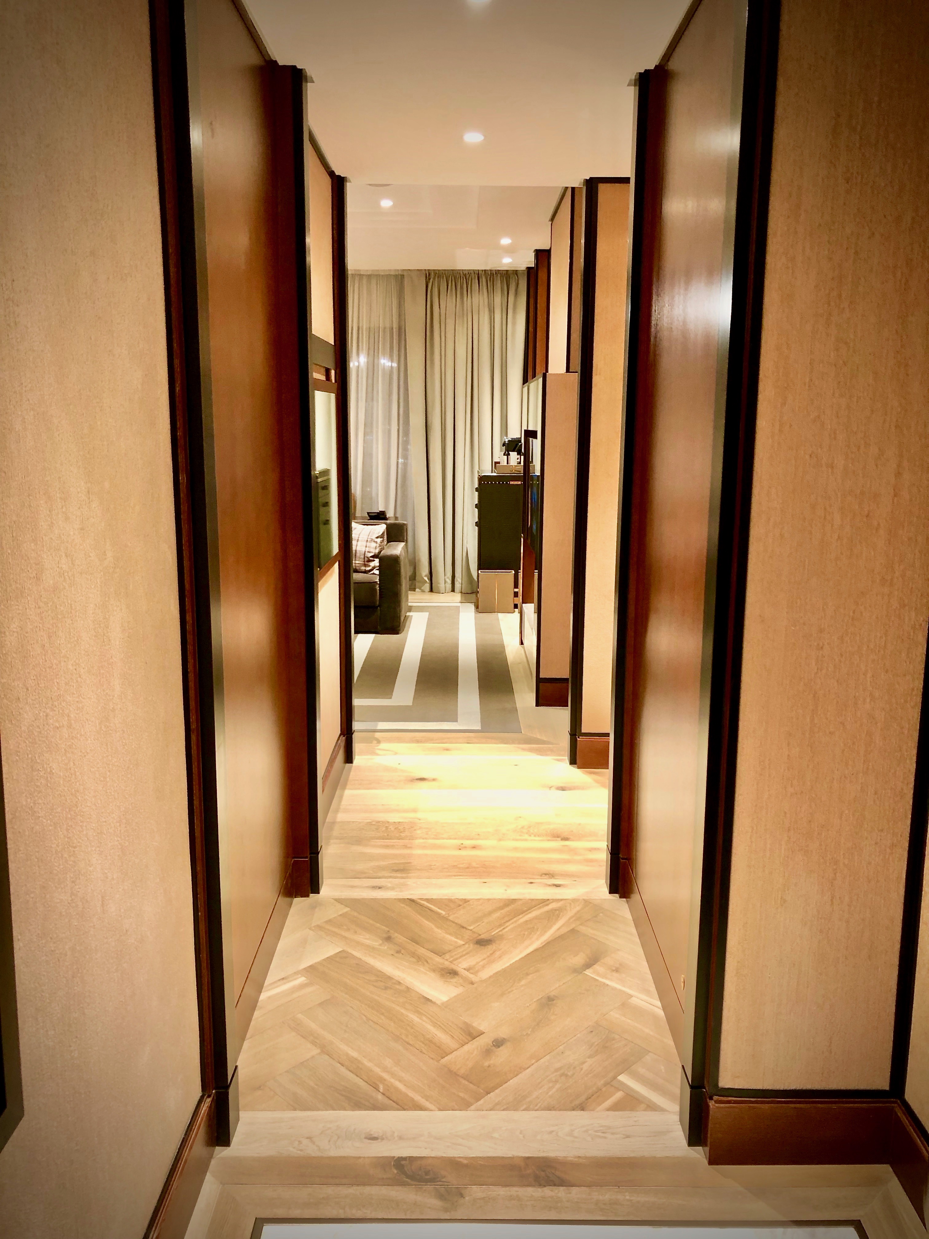 a hallway with wood doors and a carpet