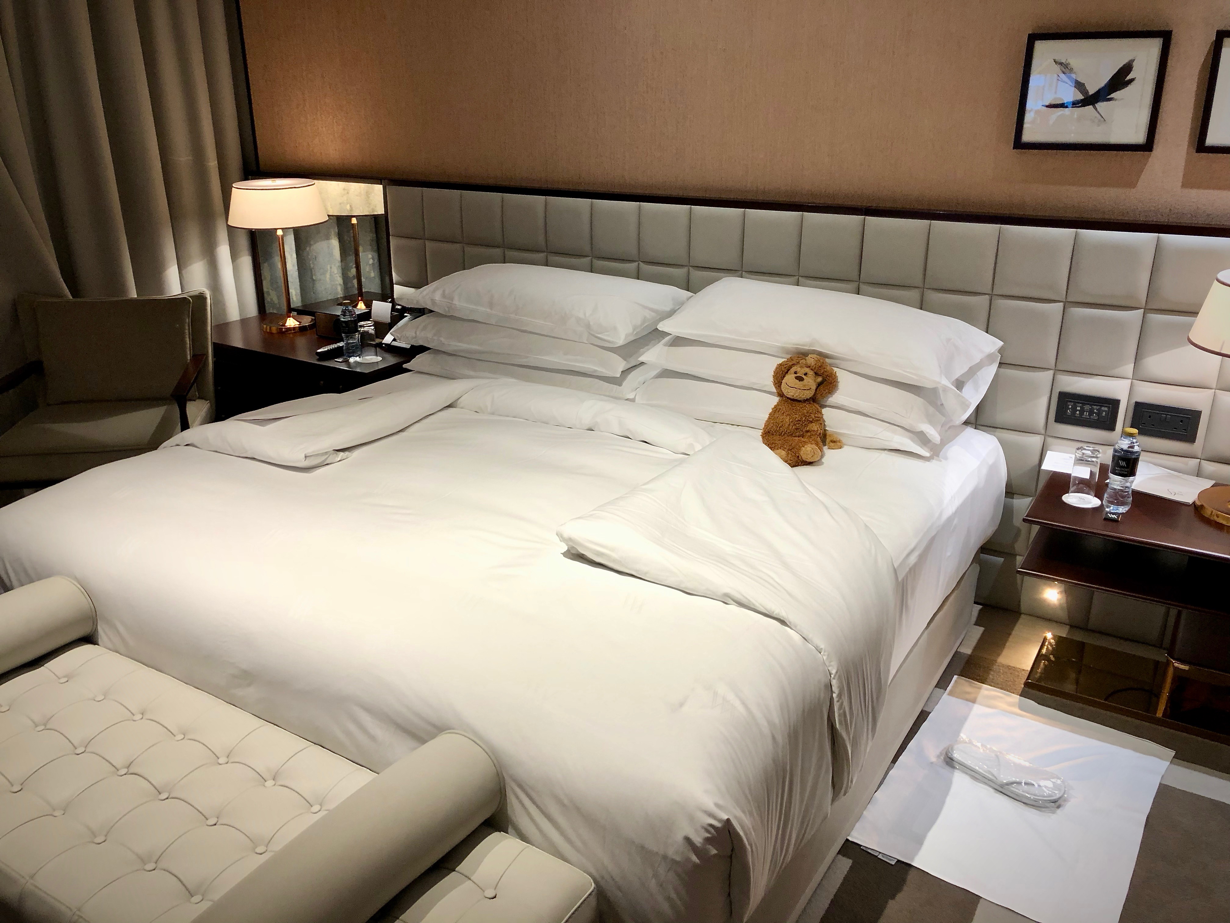 a stuffed teddy bear on a bed