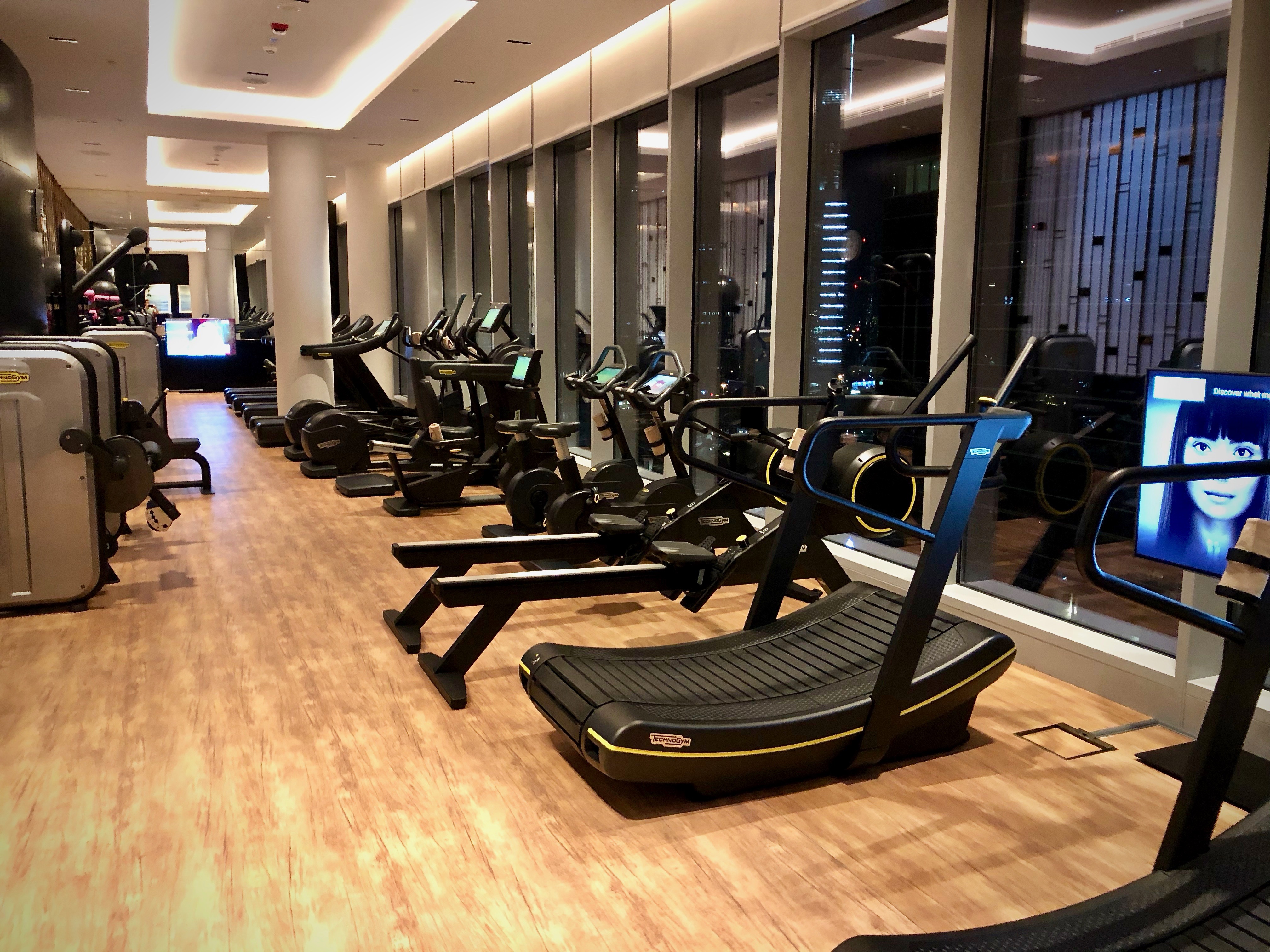 a room with exercise machines and a large window