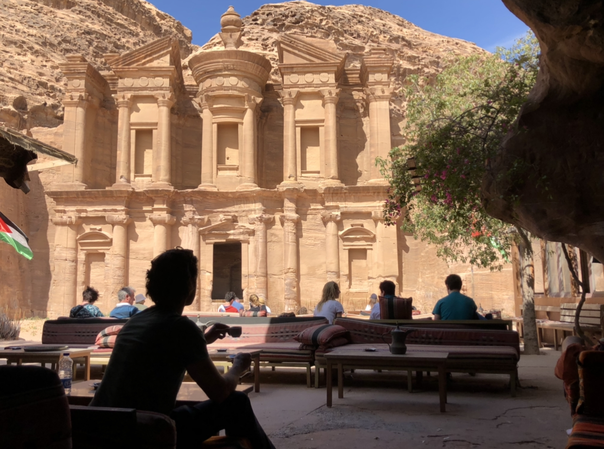 a group of people sitting outside Petra