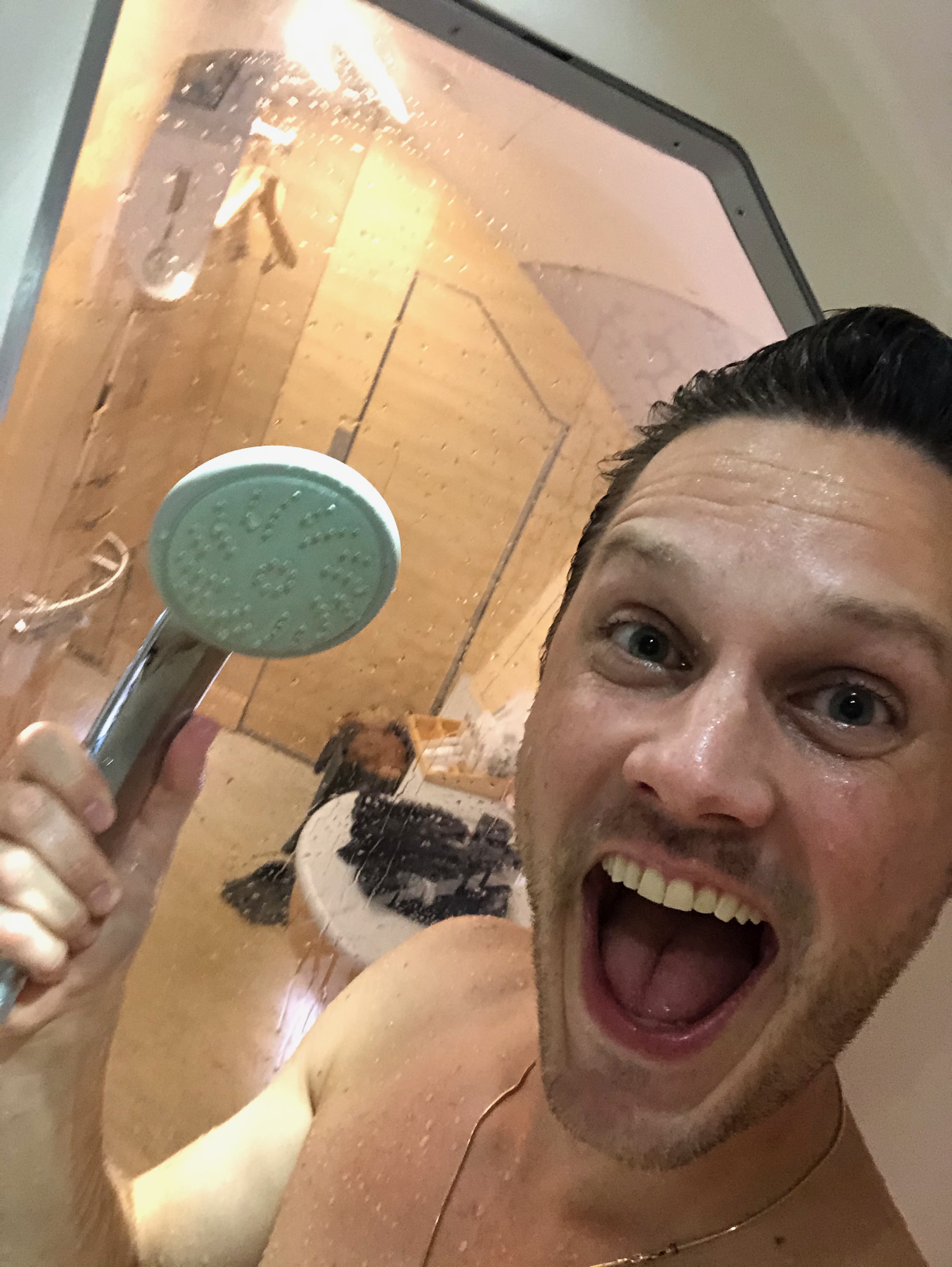 a man taking a selfie in a shower