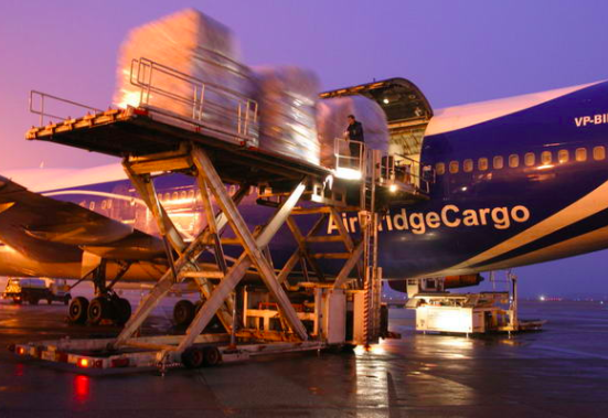 a plane loading cargo onto a platform