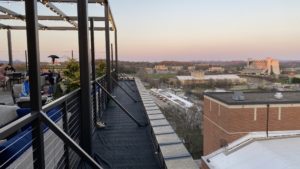 a rooftop with a view of a city and buildings