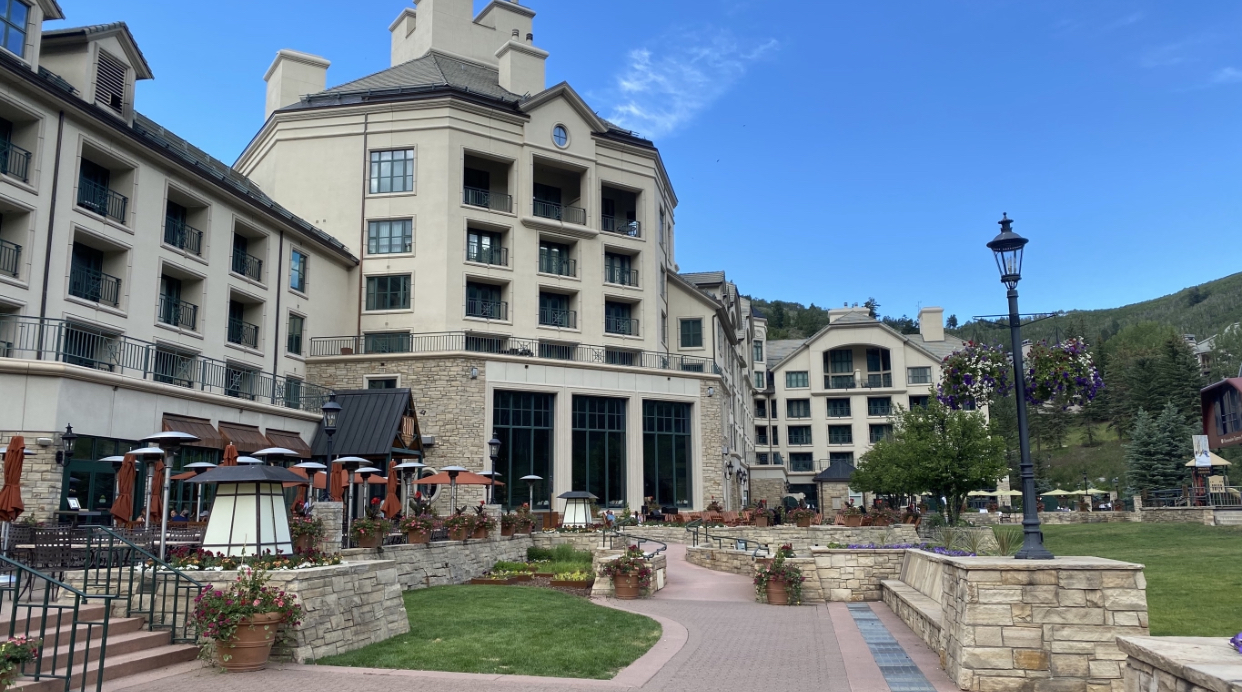 a building with a stone wall and a walkway