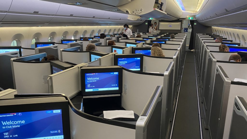 people sitting in an airplane with computers