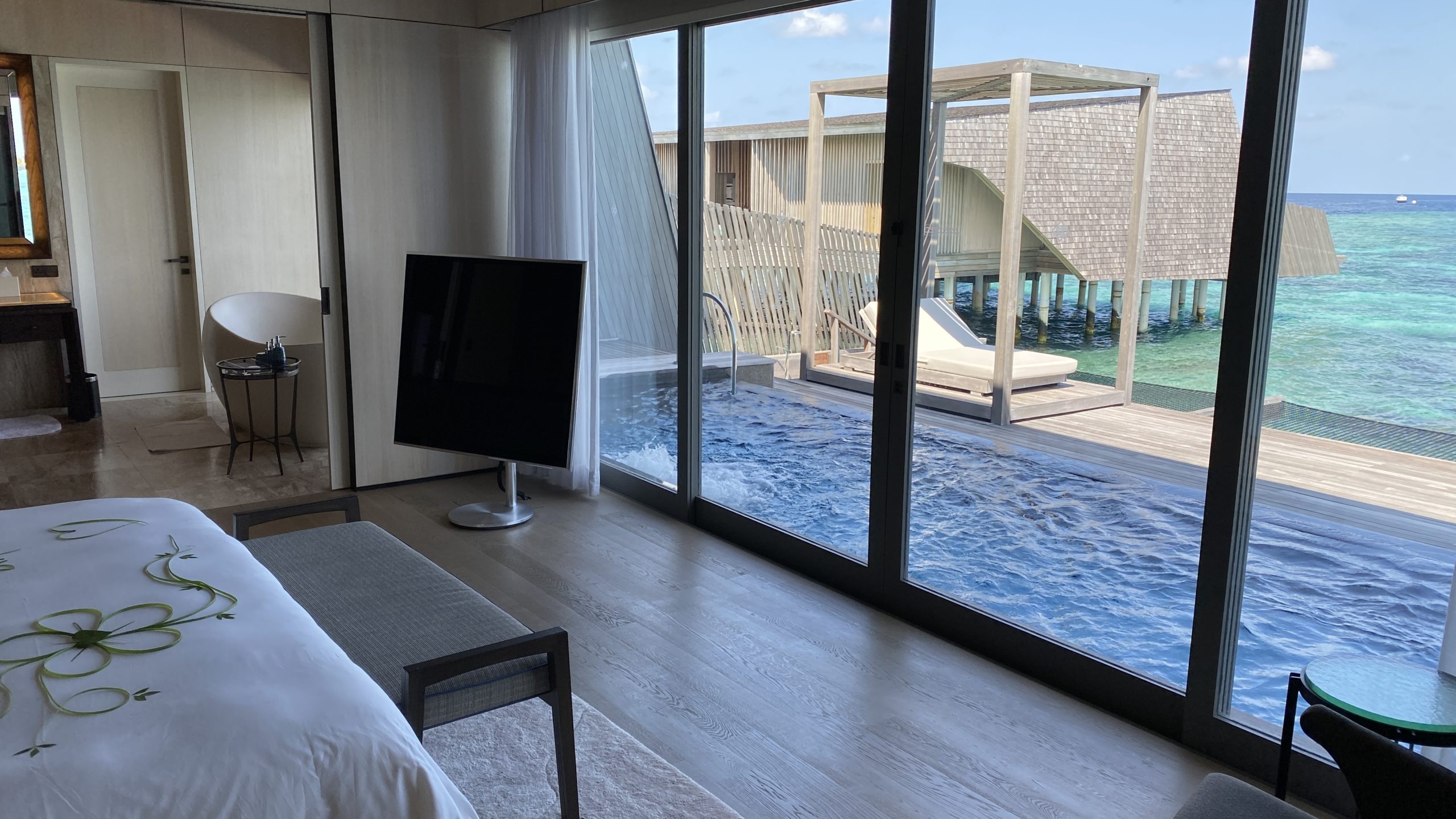 a room with a pool and a television