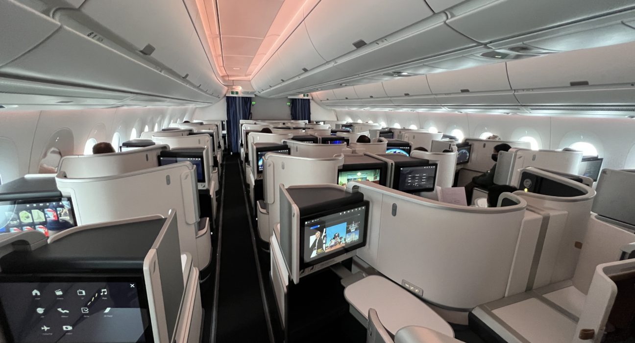an airplane with a television and a person sitting in the middle