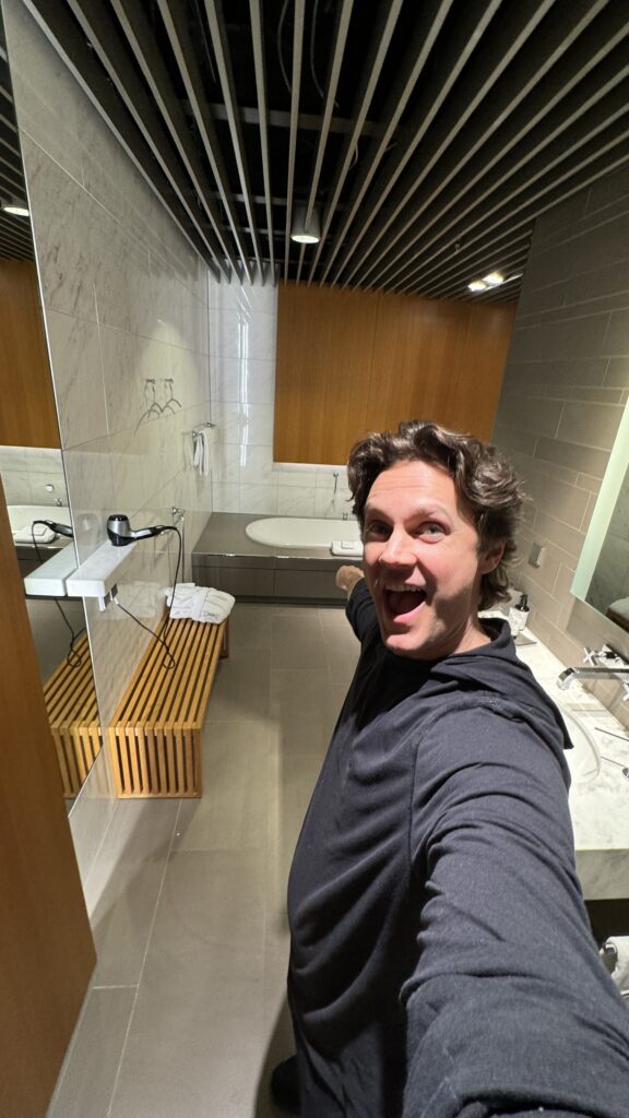 a man taking a selfie in a bathroom