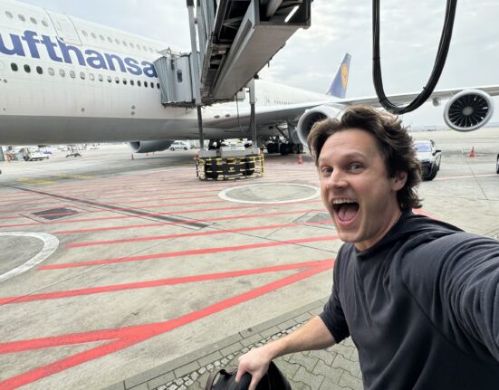 a man taking a selfie with an airplane