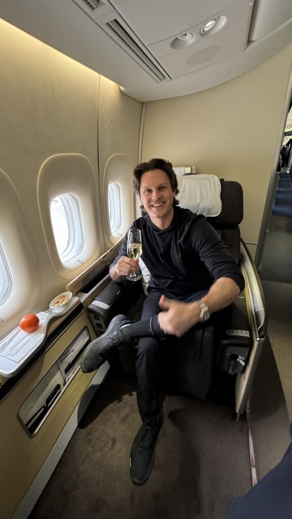 a man sitting in a chair with a glass of champagne