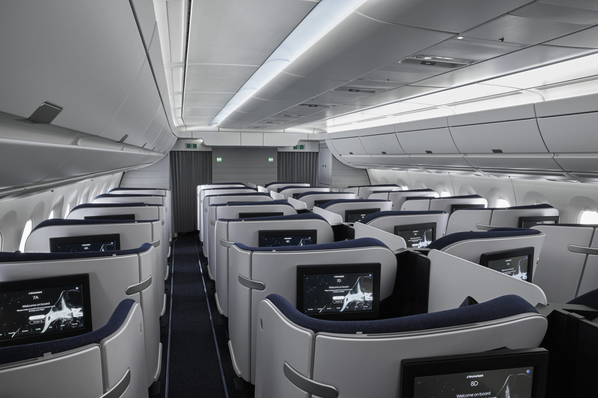 an airplane with rows of seats and monitors