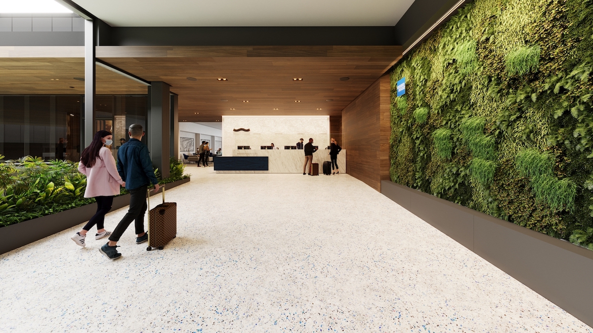 a lobby with a green wall and people walking